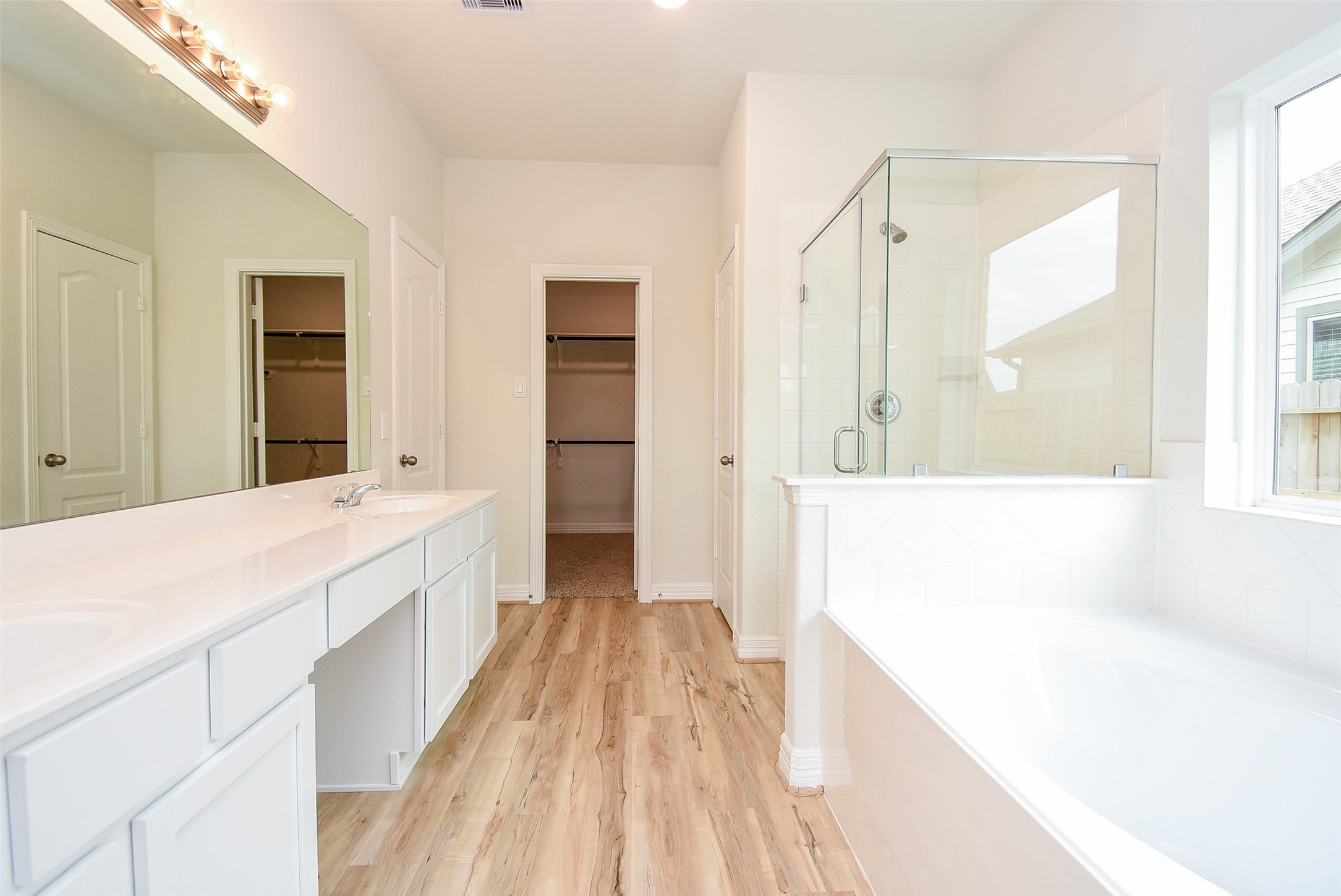 32426 Fly Fish Way Fulshear, TX 77441 - Photo 19 of 32 a spacious bathroom with a tub sink and mirror