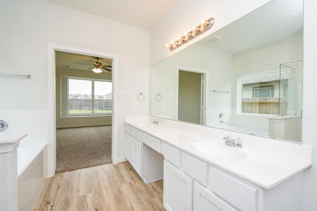 a en suite bathroom with a sink mirror and