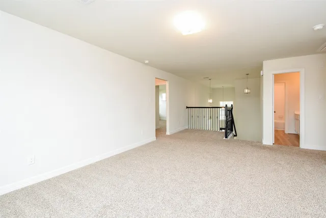 an empty room with closet and bathroom view