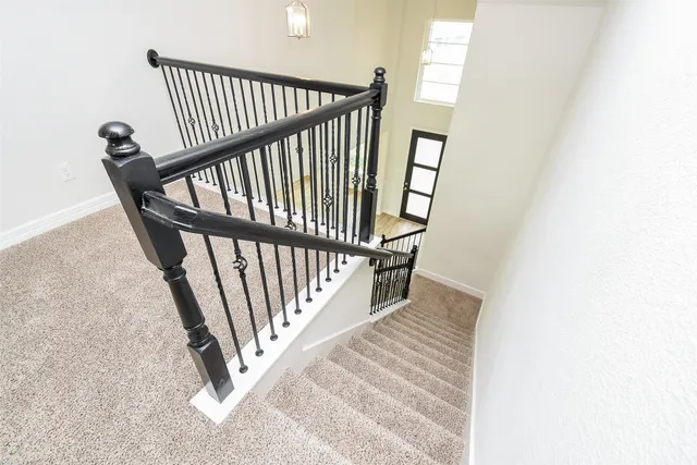 a view of a staircase with wooden floor and a window