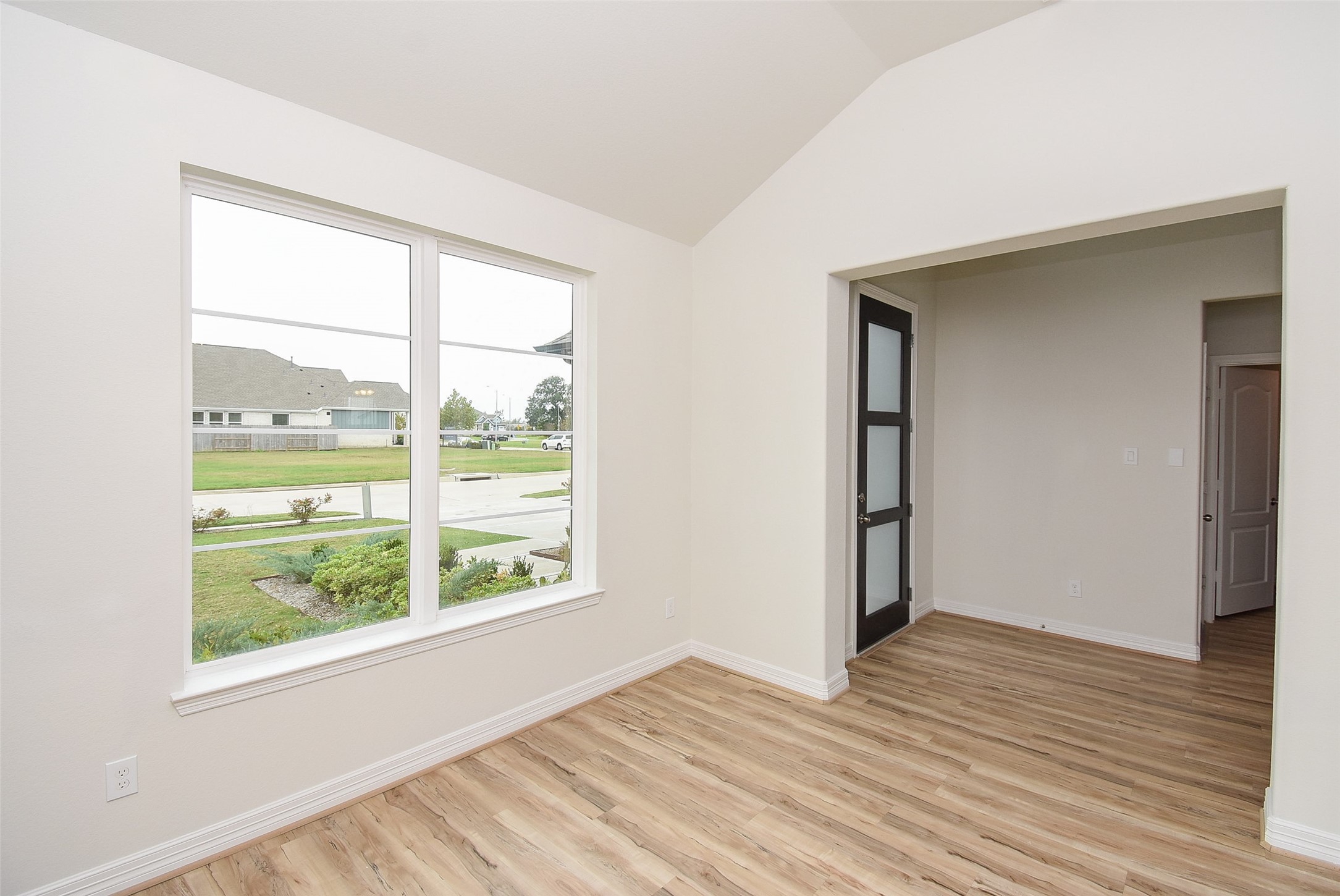 32426 Fly Fish Way Fulshear, TX 77441 - Photo 5 of 32 an empty room with wooden floor and windows