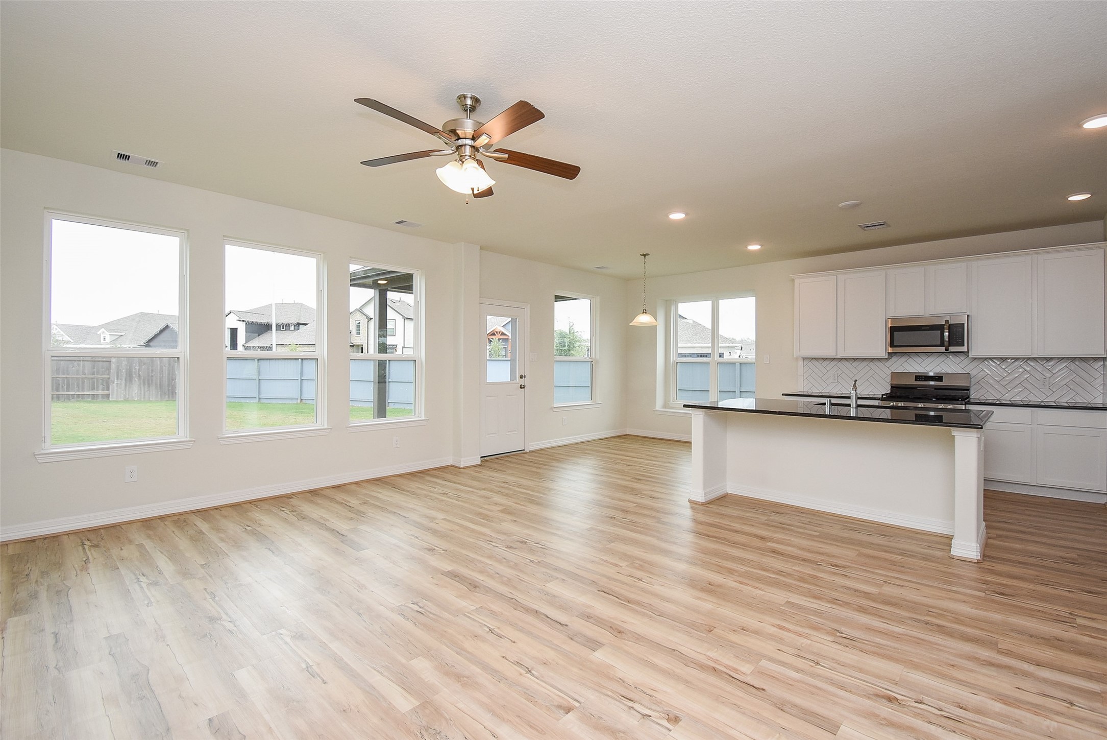 32426 Fly Fish Way Fulshear, TX 77441 - Photo 8 of 32 a view of an empty room with window and wooden floor