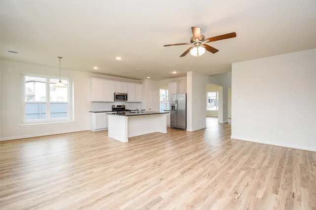 a view of kitchen with refrigerator and window