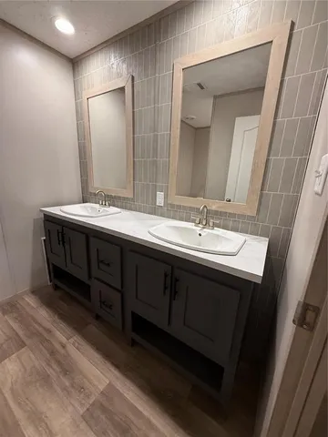 a bathroom with a double vanity sink and a mirror