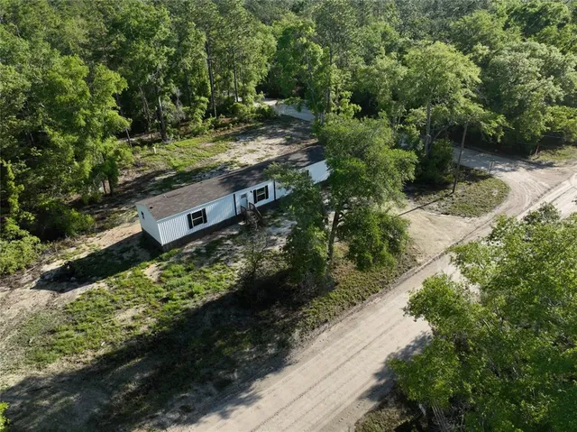 an aerial view of residential house with outdoor space