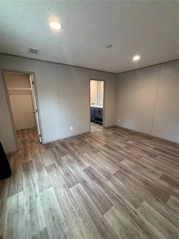 an empty room with wooden floor and a window