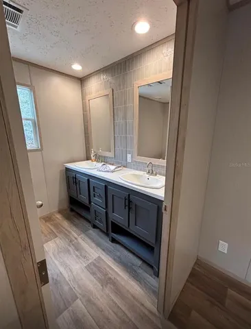 a bathroom with a double vanity sink and mirror