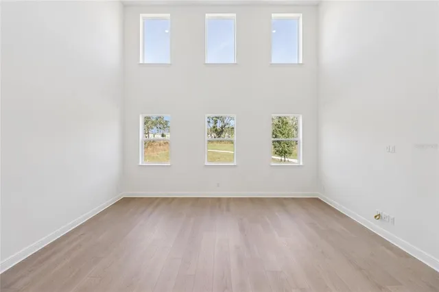 a view of a kitchen with wooden floor and electronic appliances