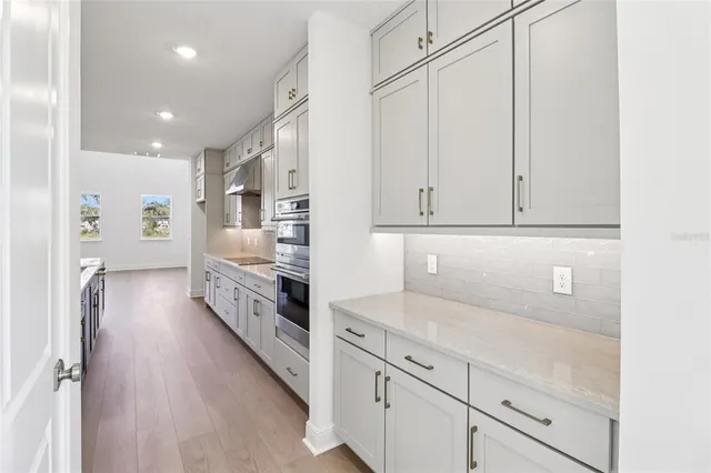 a kitchen with stainless steel appliances a sink stove and cabinets