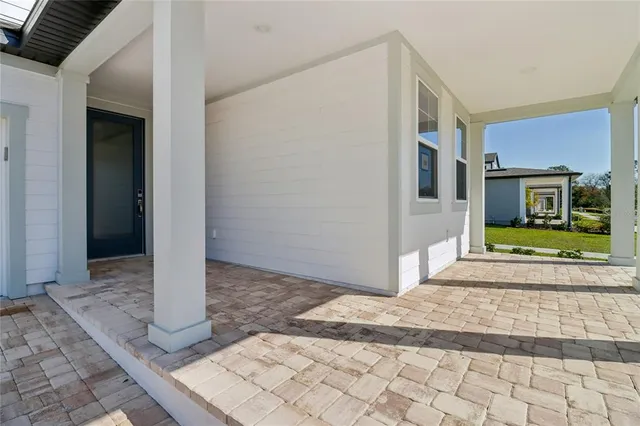 a view of a hallway with wooden floor and entryway
