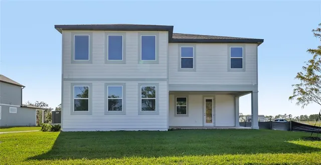 a backyard of a house with lots of green space