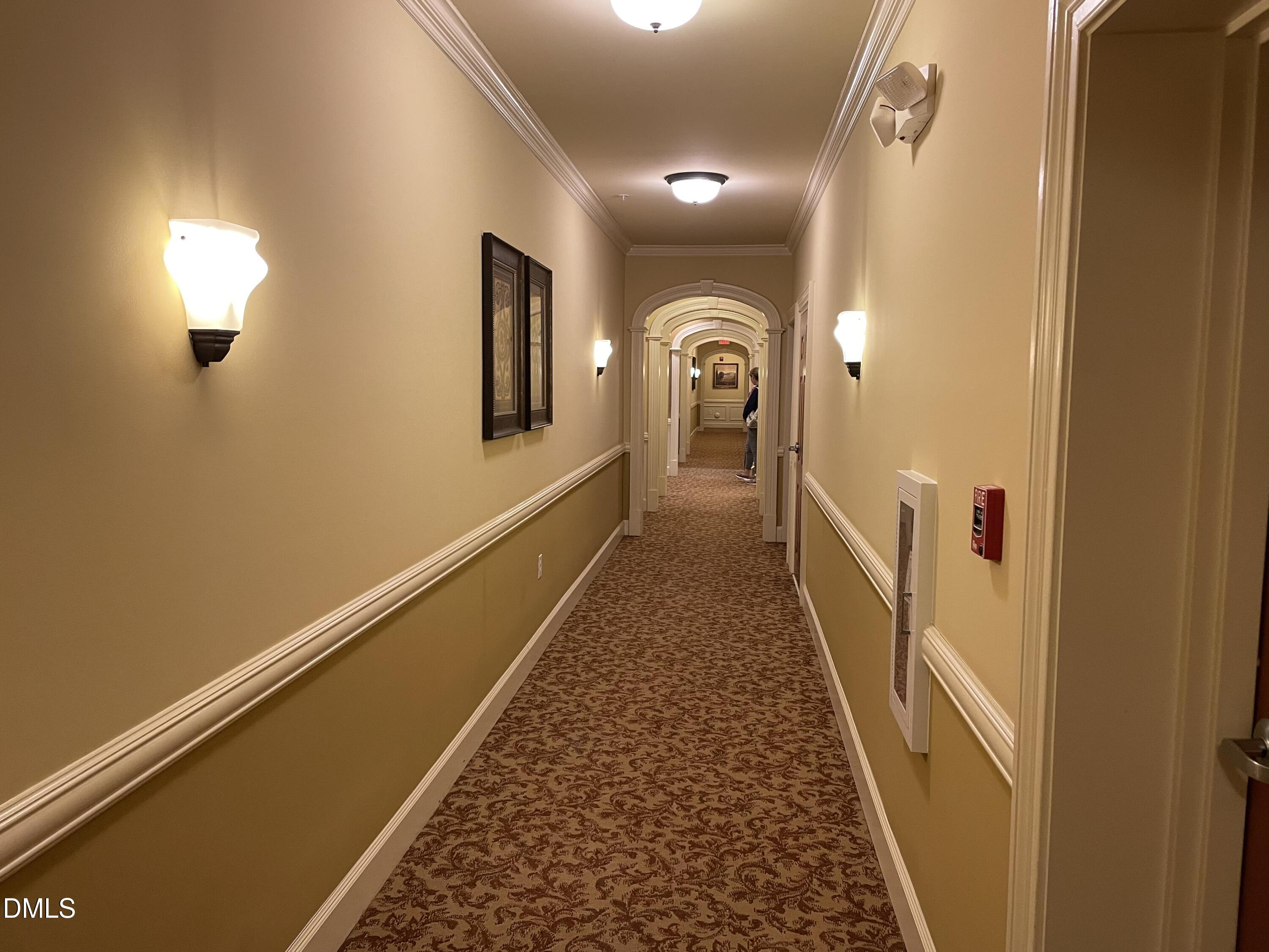10411 Rosegate Court, Unit 3 Raleigh, NC 27617 - Photo 46 of 62 a view of a hallway with wooden floor and staircase