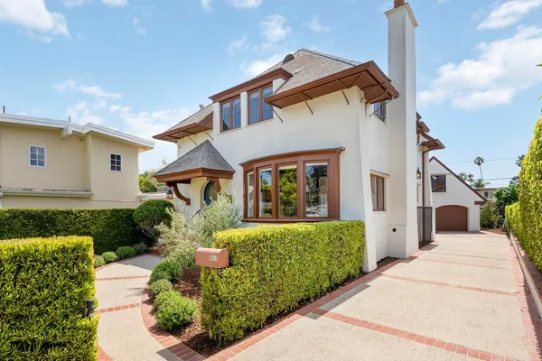 a front view of a house with garden