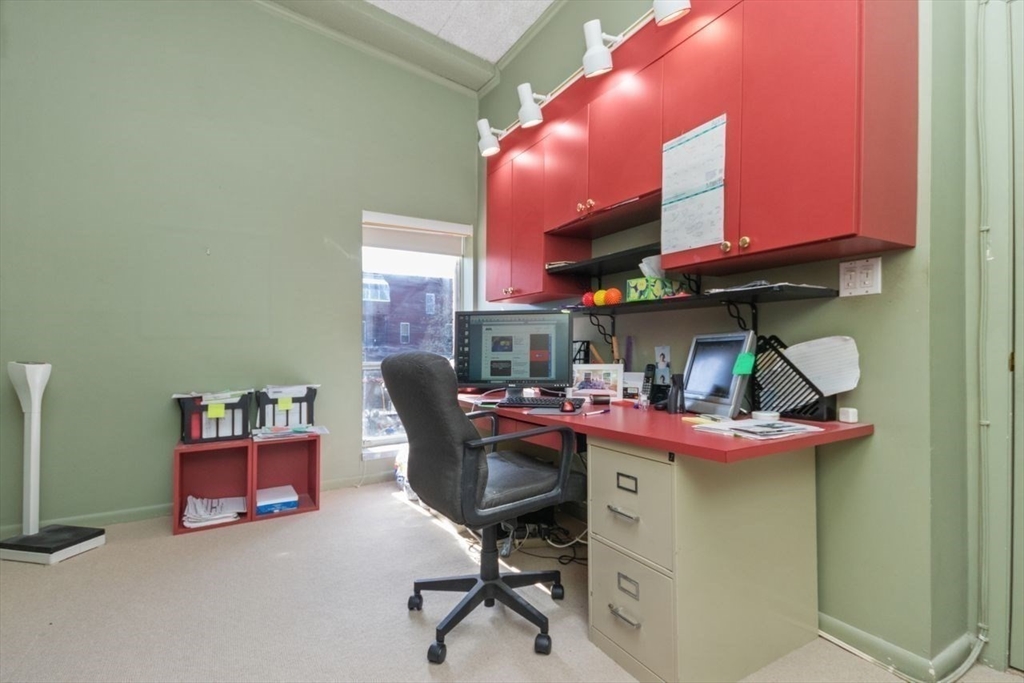 55 Broadlawn Park, Unit 11B Boston, MA 02467 - Photo 15 of 25 a room with stainless steel appliances lots of wooden furniture