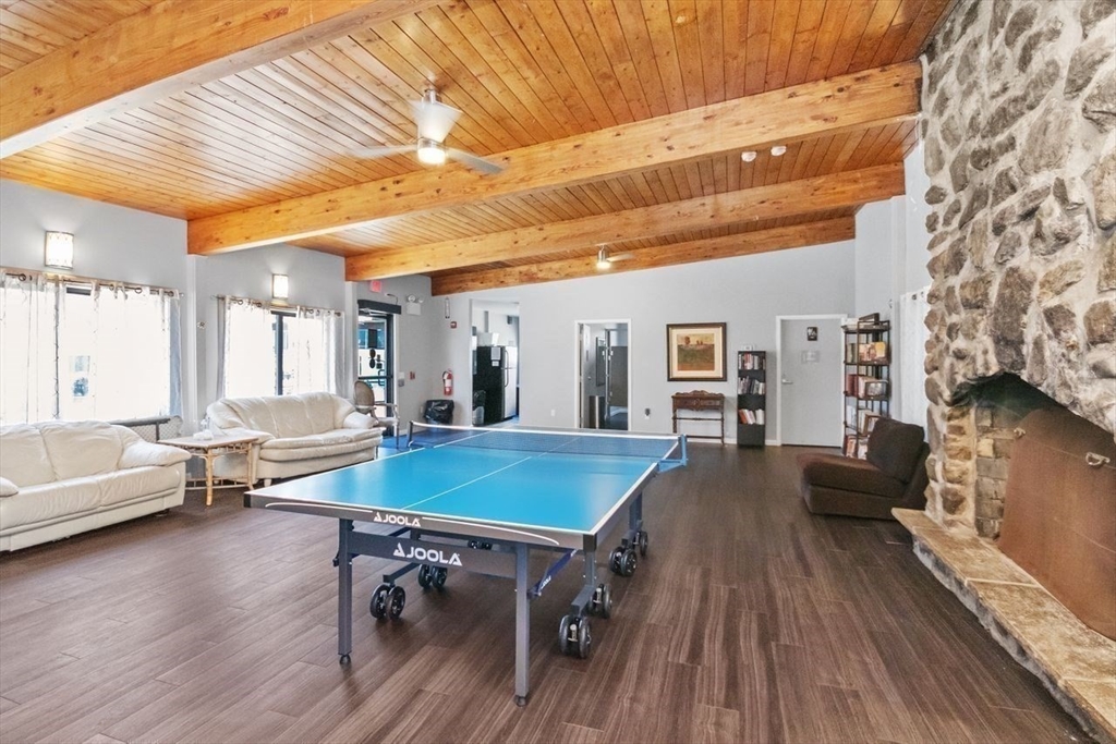 55 Broadlawn Park, Unit 11B Boston, MA 02467 - Photo 21 of 25 a living room with furniture and wooden floor