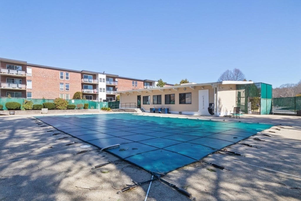 55 Broadlawn Park, Unit 11B Boston, MA 02467 - Photo 23 of 25 a view of a house with a yard