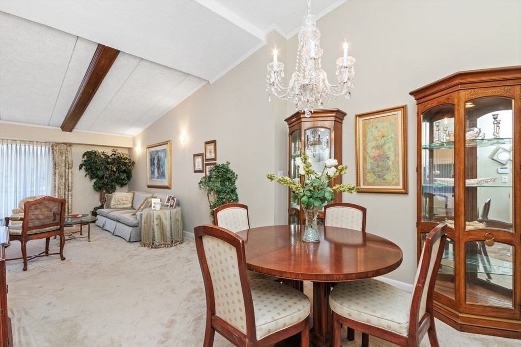 55 Broadlawn Park, Unit 11B Boston, MA 02467 - Photo 3 of 25 a view of a dining room with furniture window and outside view