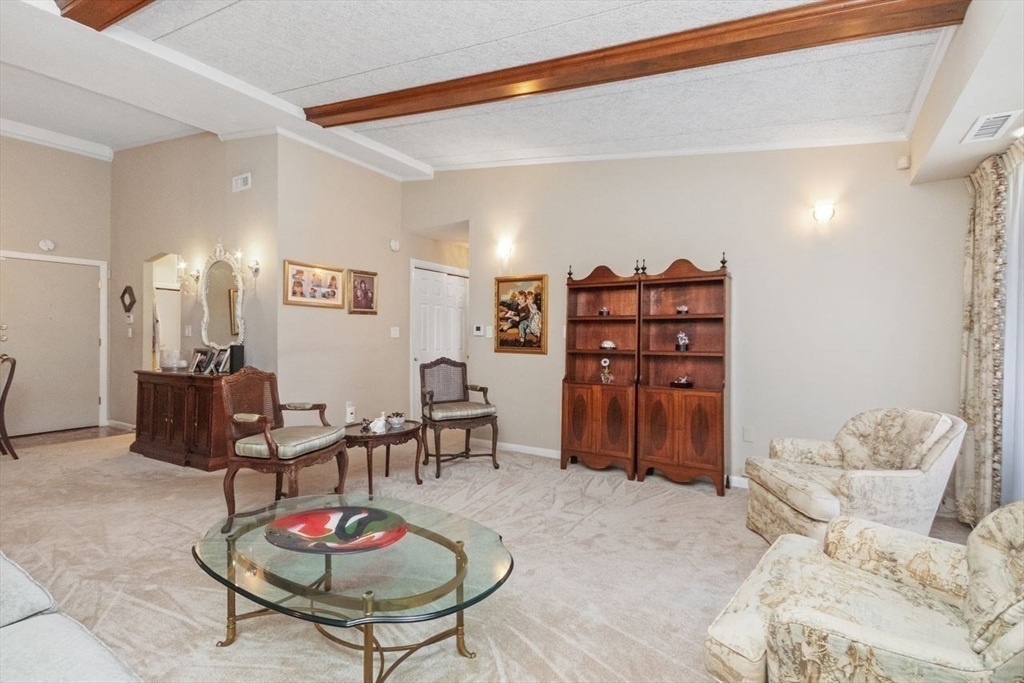 55 Broadlawn Park, Unit 11B Boston, MA 02467 - Photo 5 of 25 a living room with furniture and wooden floor