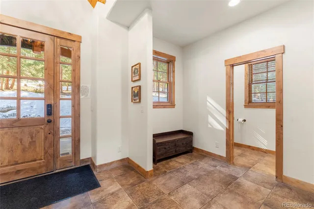 an empty room with windows and wardrobe