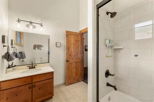 a bathroom with a shower sink and mirror