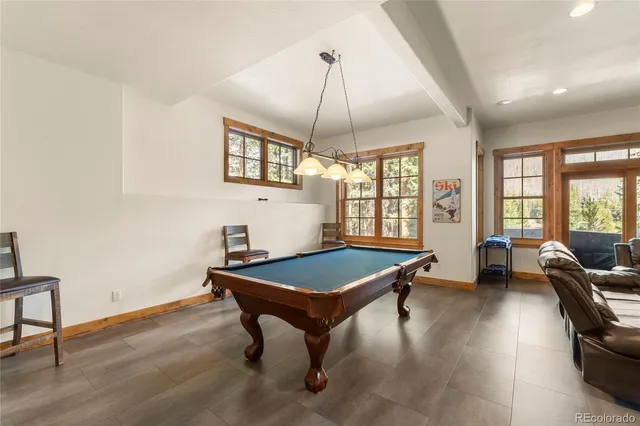 a living room with furniture a flat screen tv and a large window