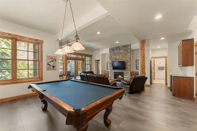a living room with furniture a flat screen tv and a large window