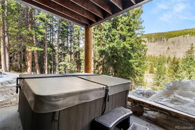 a bedroom with a bed and a lamp on dresser