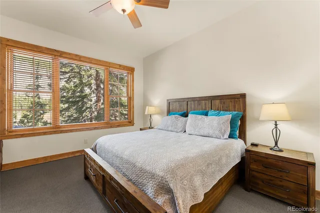 a view of a house with a yard and large trees