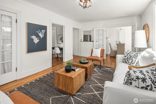 a living room with furniture and wooden floor