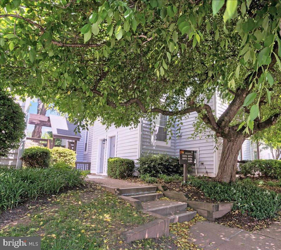 10096 Oakton Terrace Road, Unit 10096 Oakton, VA 22124 - Photo 1 of 24 a front view of a house with garden