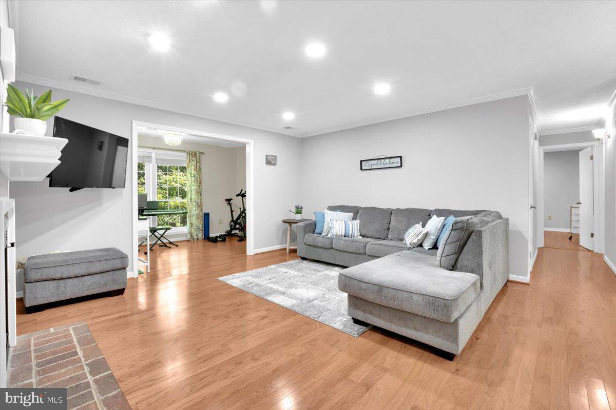 10096 Oakton Terrace Road, Unit 10096 Oakton, VA 22124 - Photo 11 of 24 a living room with furniture and a flat screen tv