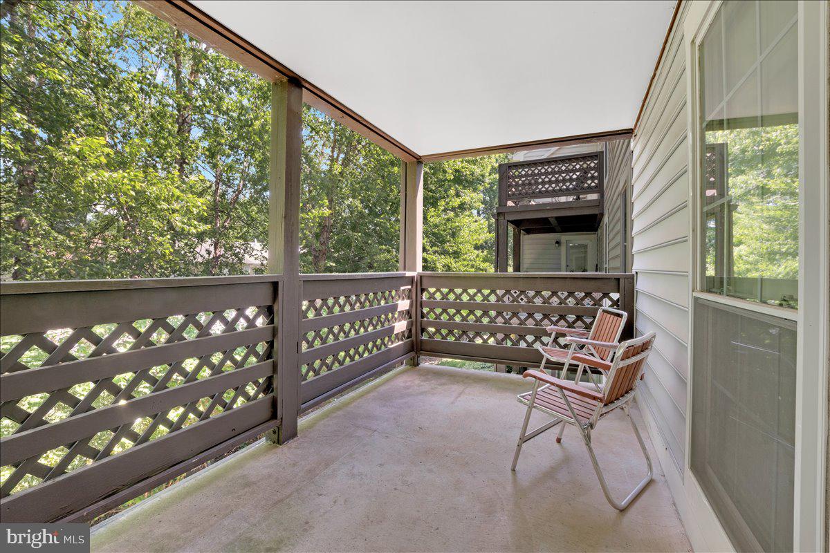 10096 Oakton Terrace Road, Unit 10096 Oakton, VA 22124 - Photo 14 of 24 a wooden bench sitting in front of a building