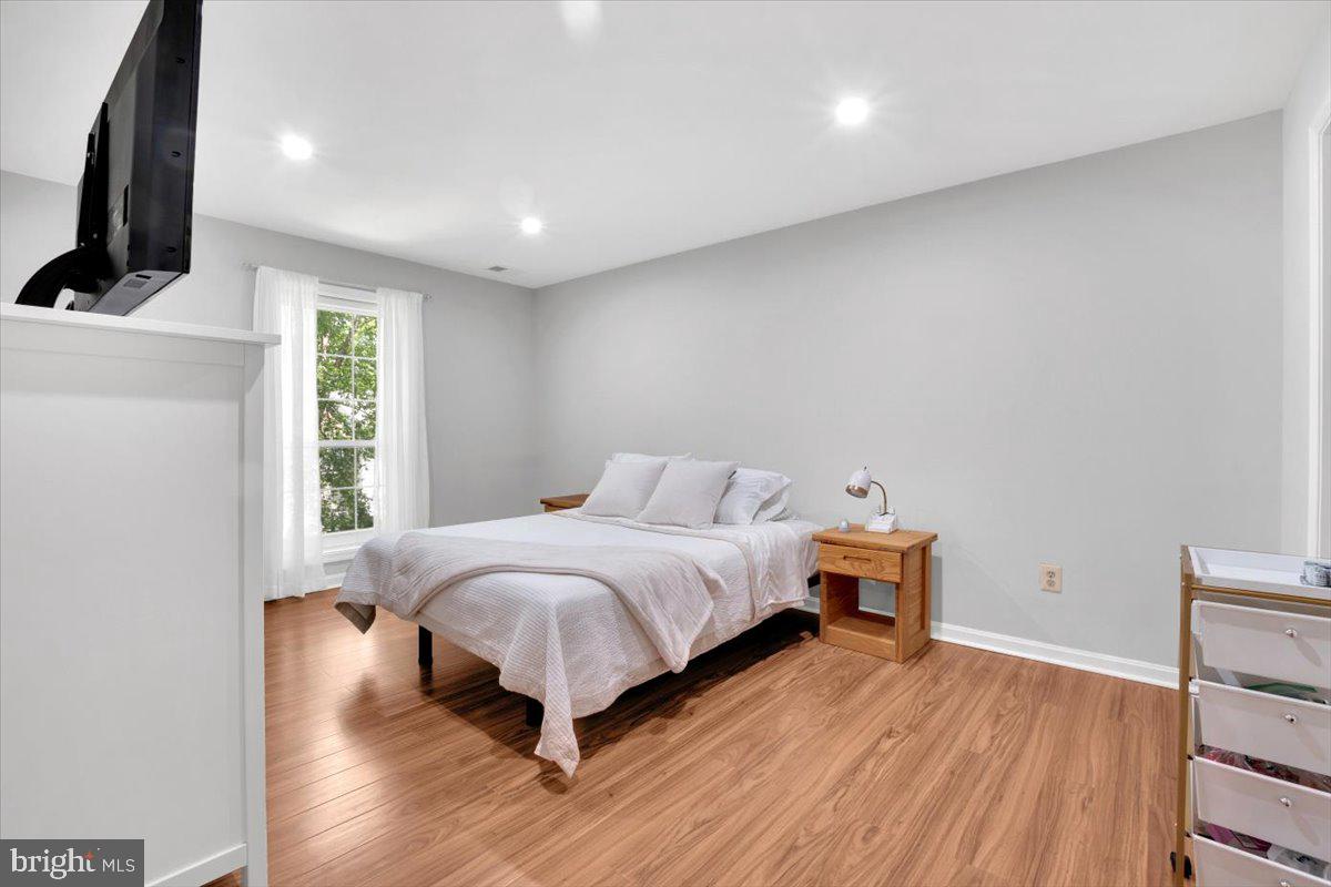10096 Oakton Terrace Road, Unit 10096 Oakton, VA 22124 - Photo 17 of 24 a bedroom with a bed and a flat screen tv