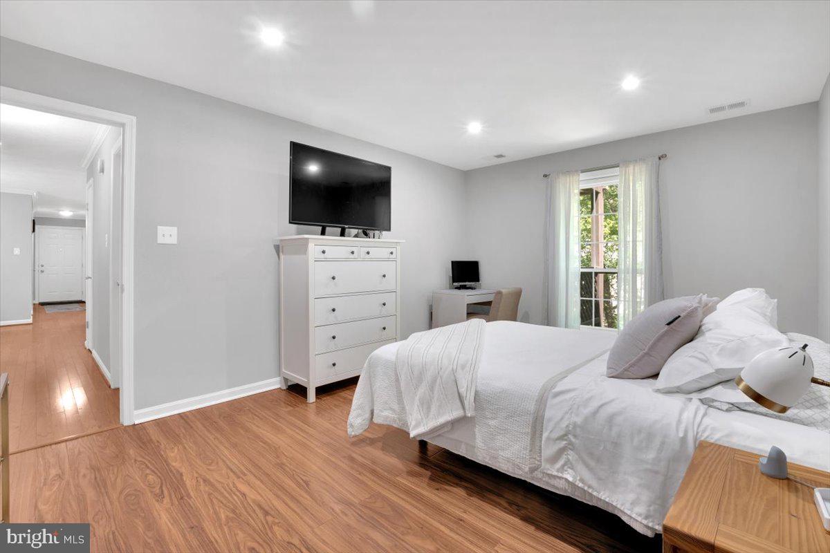 10096 Oakton Terrace Road, Unit 10096 Oakton, VA 22124 - Photo 18 of 24 a bedroom with a bed and a flat screen tv
