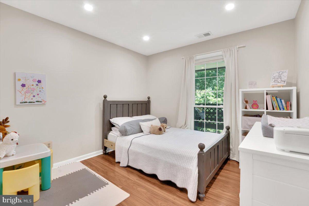 10096 Oakton Terrace Road, Unit 10096 Oakton, VA 22124 - Photo 19 of 24 a bedroom with a bed and a large window