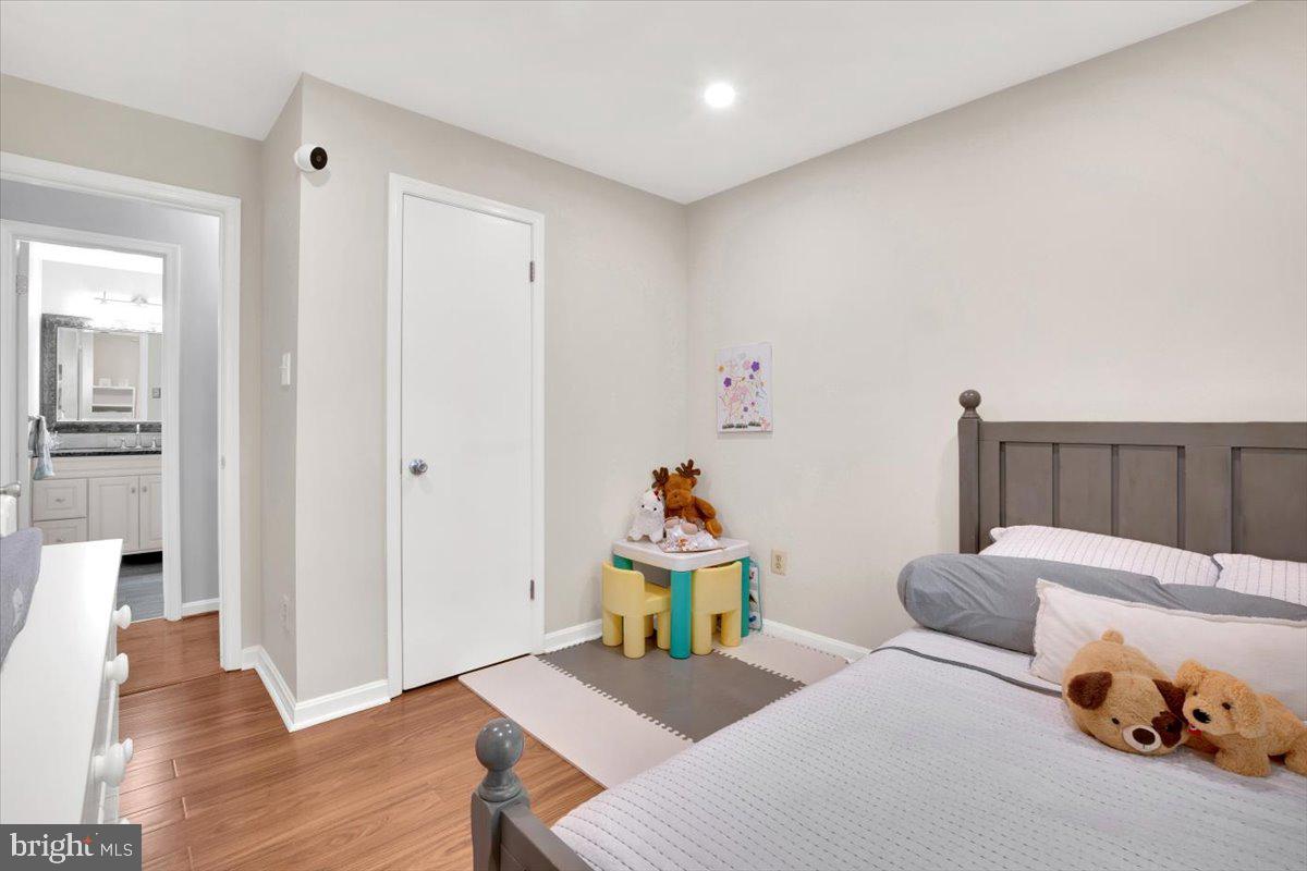 10096 Oakton Terrace Road, Unit 10096 Oakton, VA 22124 - Photo 20 of 24 a bedroom with furniture and a wooden floor