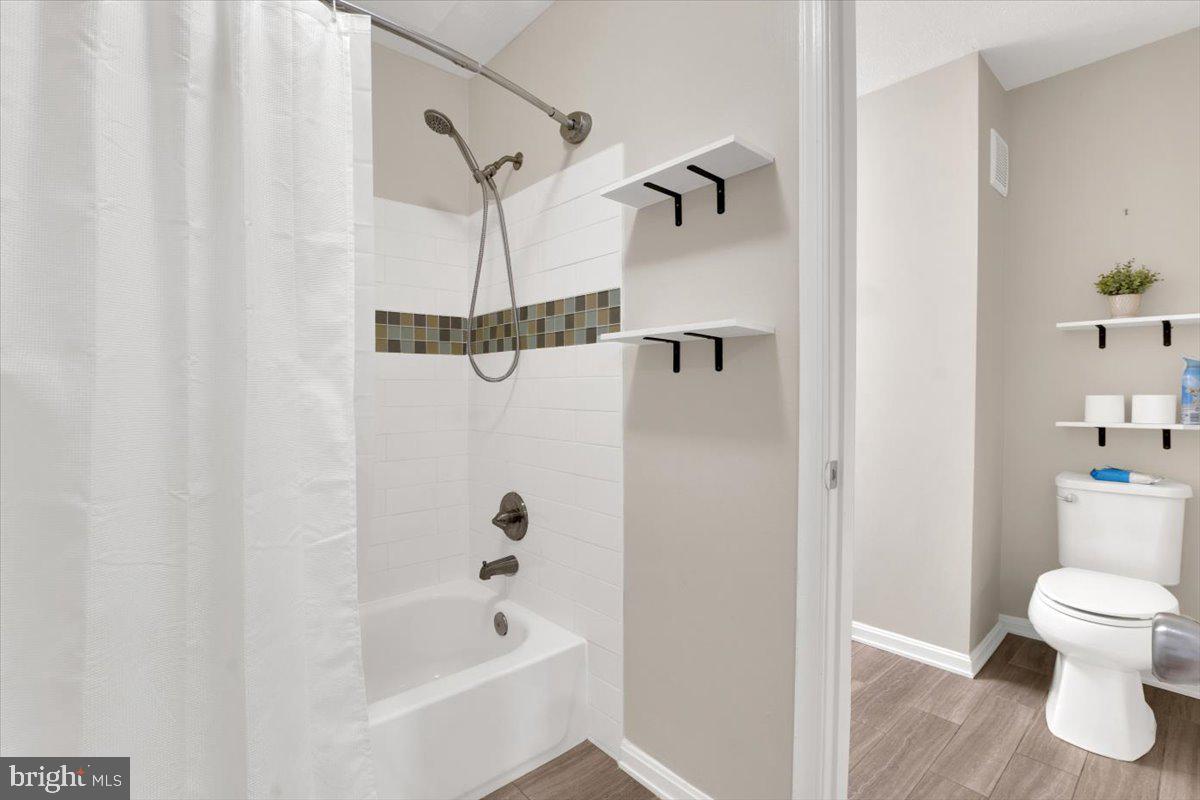 10096 Oakton Terrace Road, Unit 10096 Oakton, VA 22124 - Photo 21 of 24 a bathroom with a toilet and a shower