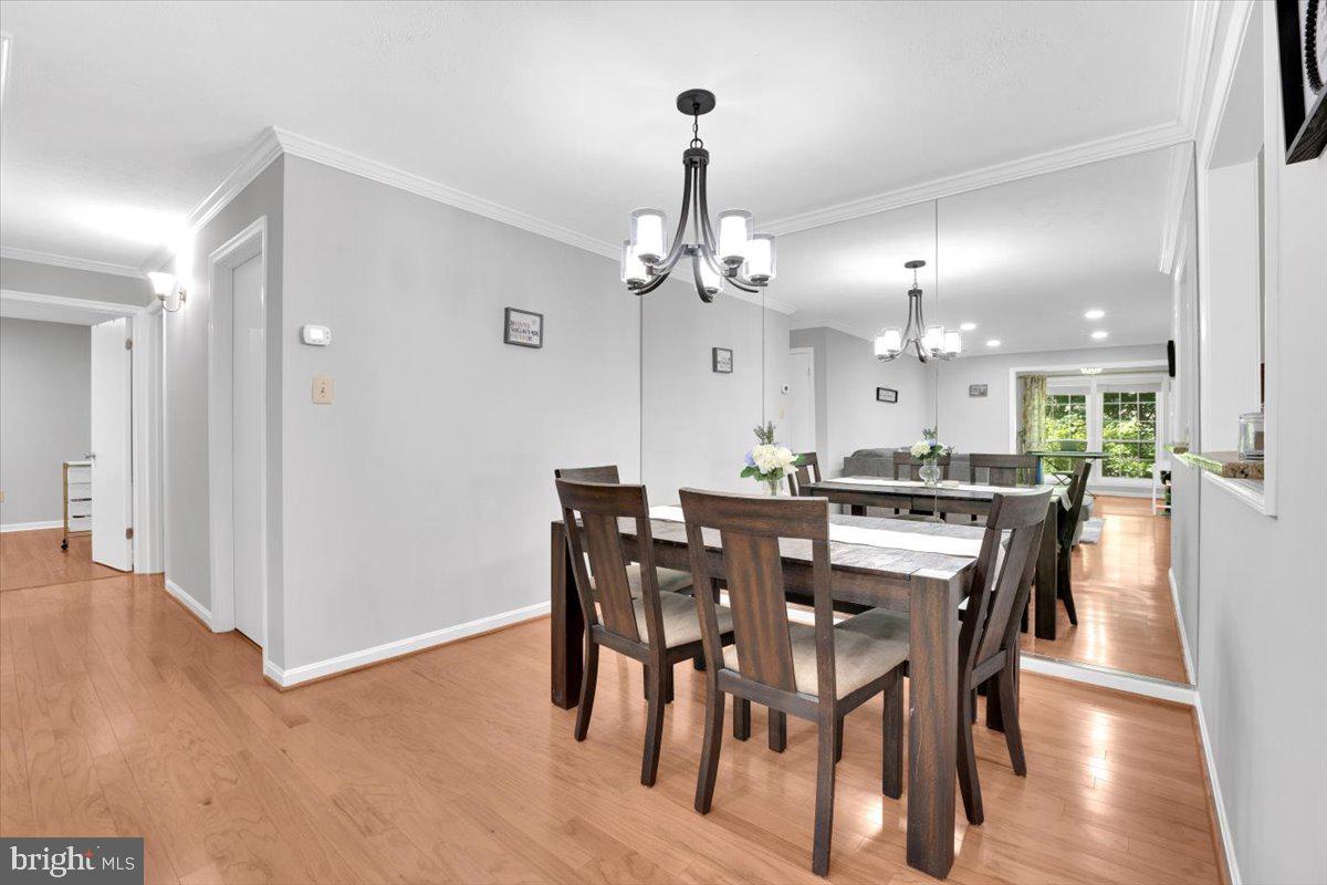 10096 Oakton Terrace Road, Unit 10096 Oakton, VA 22124 - Photo 10 of 24 a view of a dining room with furniture and wooden floor