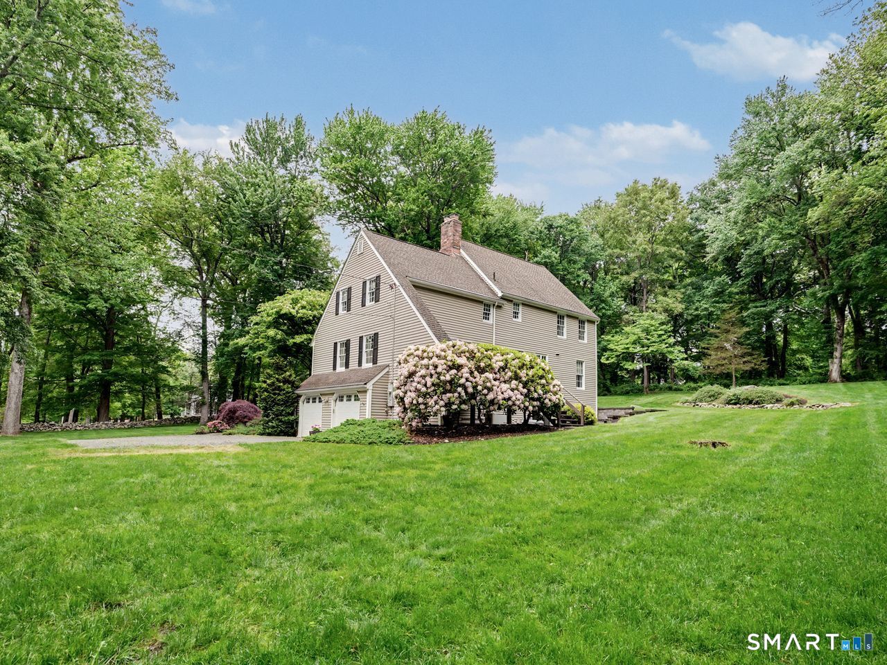 86 Fire Hill Road Redding, CT 06896 - Photo 33 of 36 a view of a house with a big yard and large trees