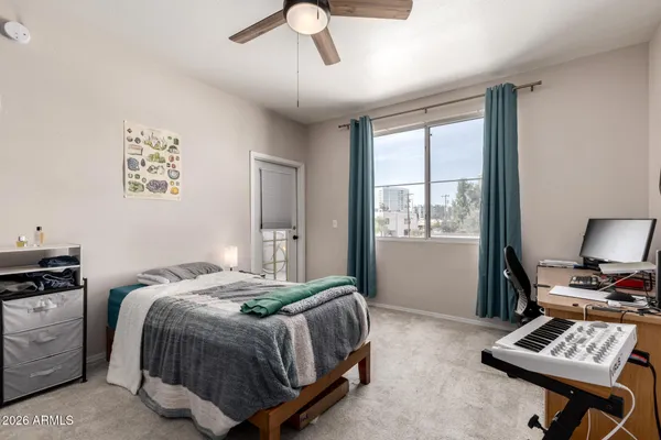 a bedroom with a bed and a window