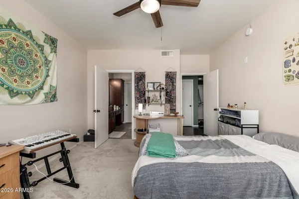 a bedroom with a bed and a chandelier