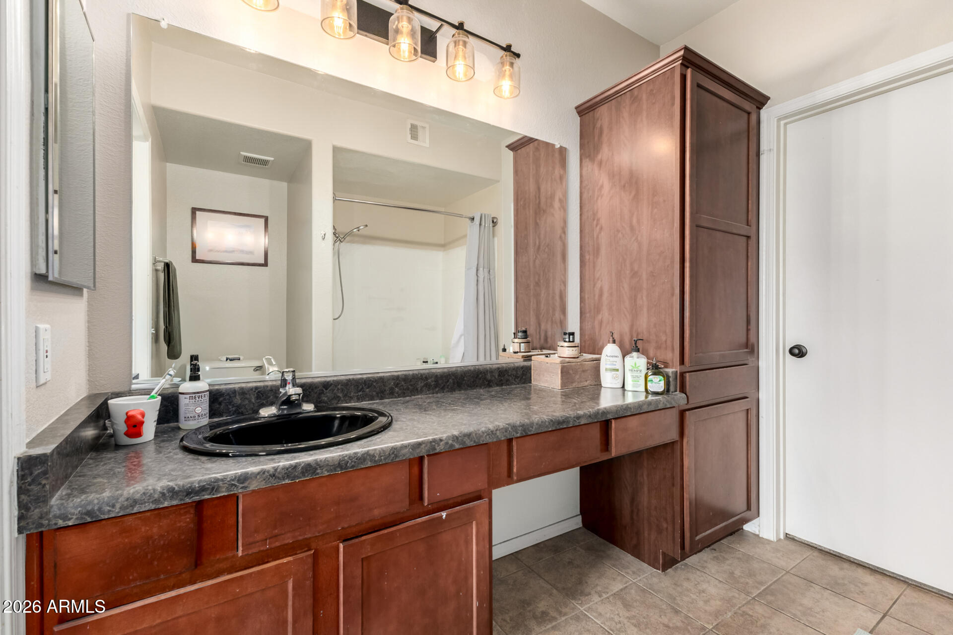 3302 North 7th Street, Unit 232 Phoenix, AZ 85014 - Photo 13 of 47 a bathroom with a granite countertop sink and a mirror