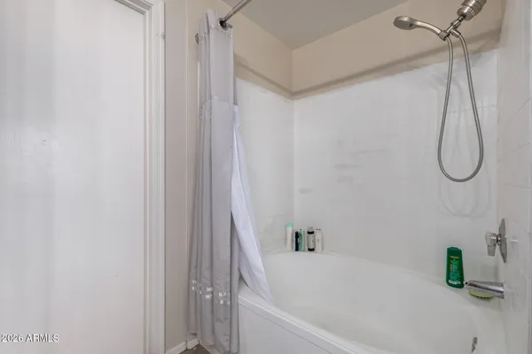 a bathroom with a bath tub with a shower