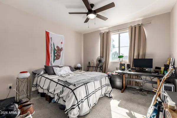 a bedroom that has a bed and a desk in it