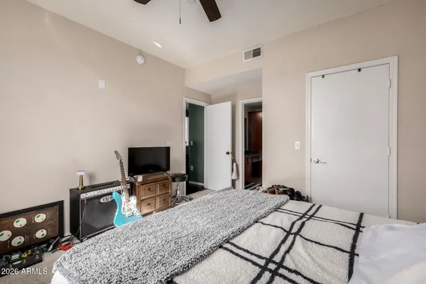 a bedroom with a bed and a flat screen tv