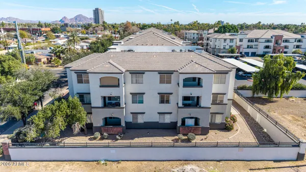 a aerial view of a house with yard porch and furniture
