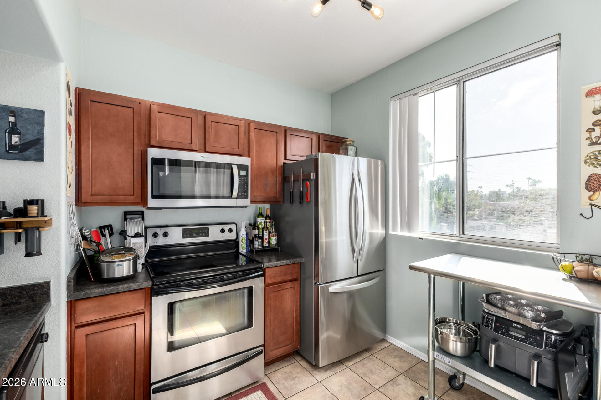 3302 North 7th Street, Unit 232 Phoenix, AZ 85014 - Photo 5 of 47 a kitchen with a refrigerator stove and microwave