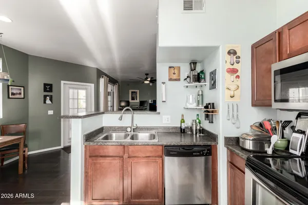 a kitchen with stainless steel appliances granite countertop a sink and cabinets