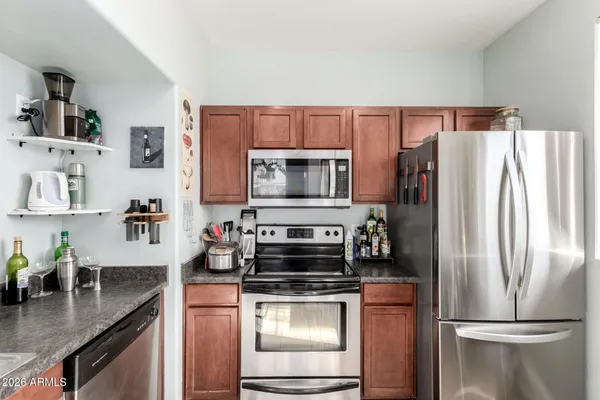a kitchen with a refrigerator stove and microwave