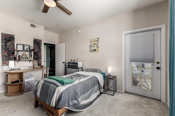 a bedroom with a bed closet and flat tv screen